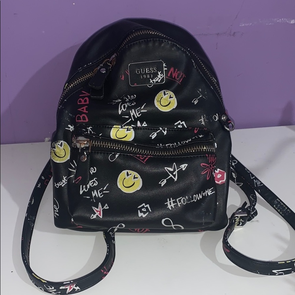 Small black backpack with yellow smiley faces